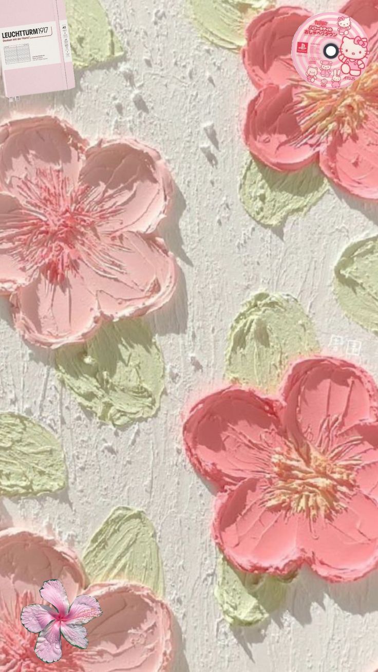 some pink flowers and green leaves on a white surface