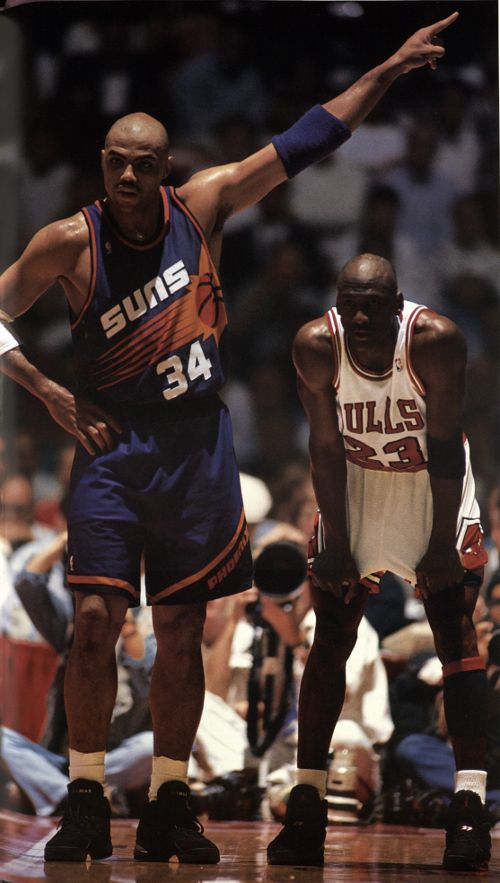 two basketball players standing next to each other