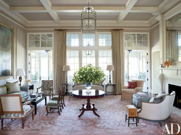 a living room filled with furniture and a fire place in the middle of a room