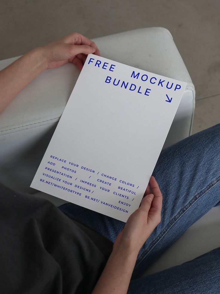 a person sitting on a couch holding up a paper with the text free mockup bundle