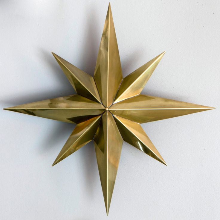 a gold metal star hanging on the wall