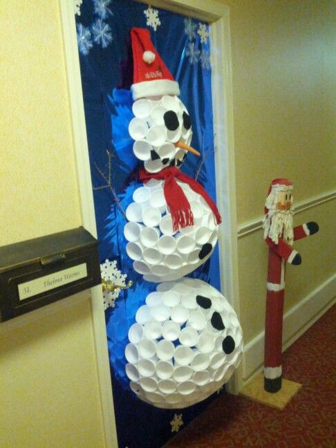 a door decorated with paper plates and snowmen