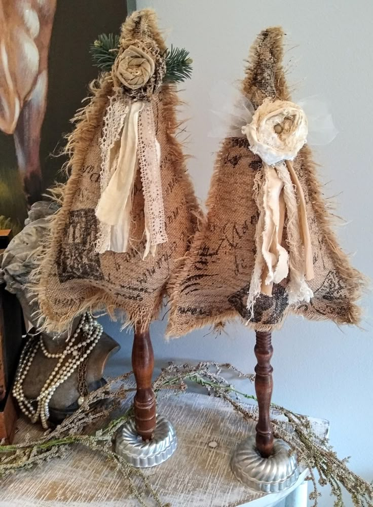 two burlap christmas trees on top of a table