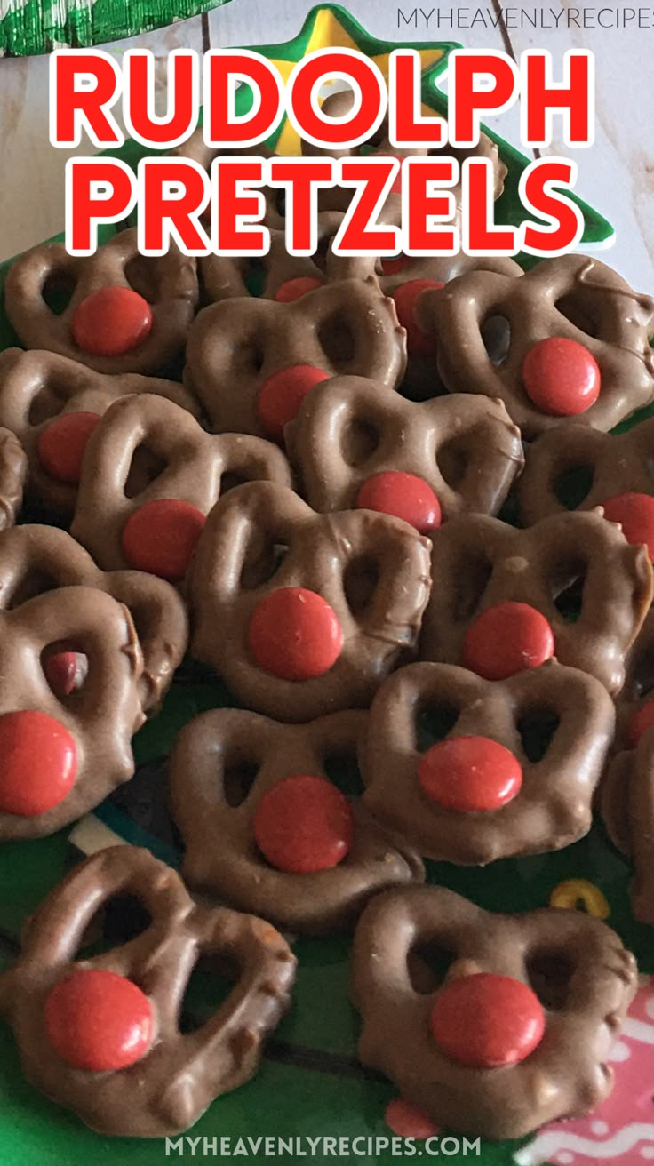 chocolate pretzels are arranged on a green platter with christmas trees and decorations