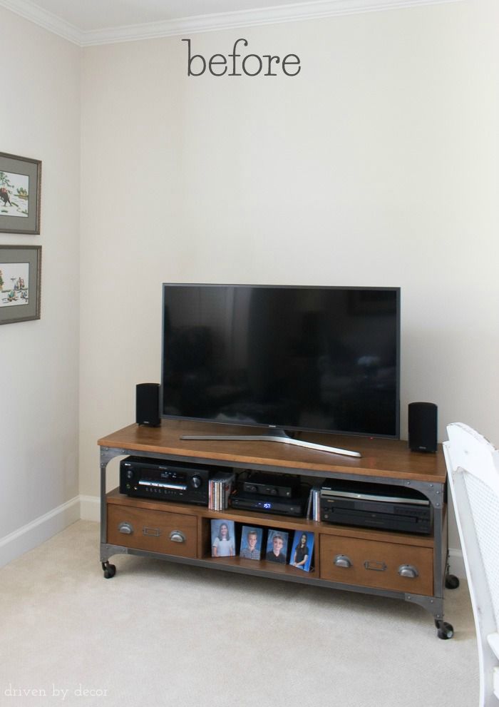 a flat screen tv sitting on top of a wooden entertainment center