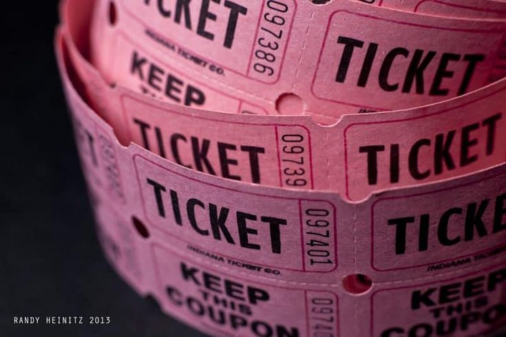 pink tickets are stacked on top of each other