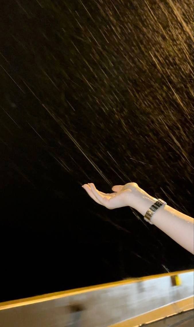 a person holding an umbrella in the rain