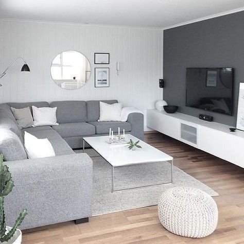 a living room filled with furniture and a flat screen tv on top of a wooden floor