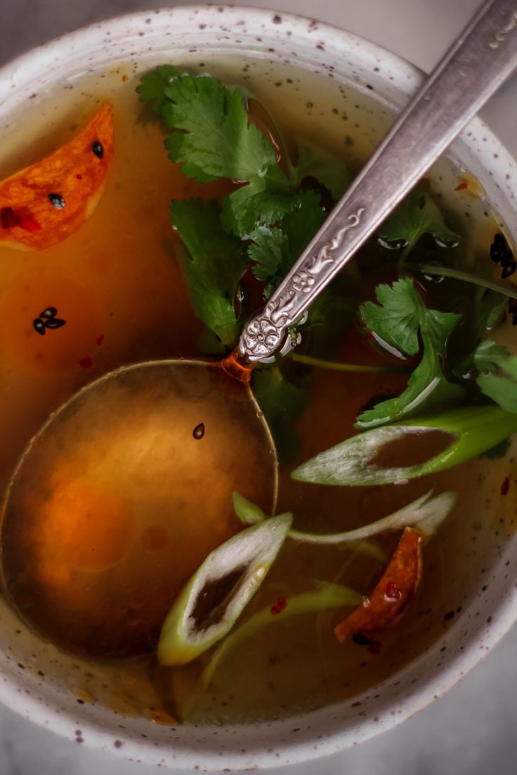 a white bowl filled with soup and vegetables