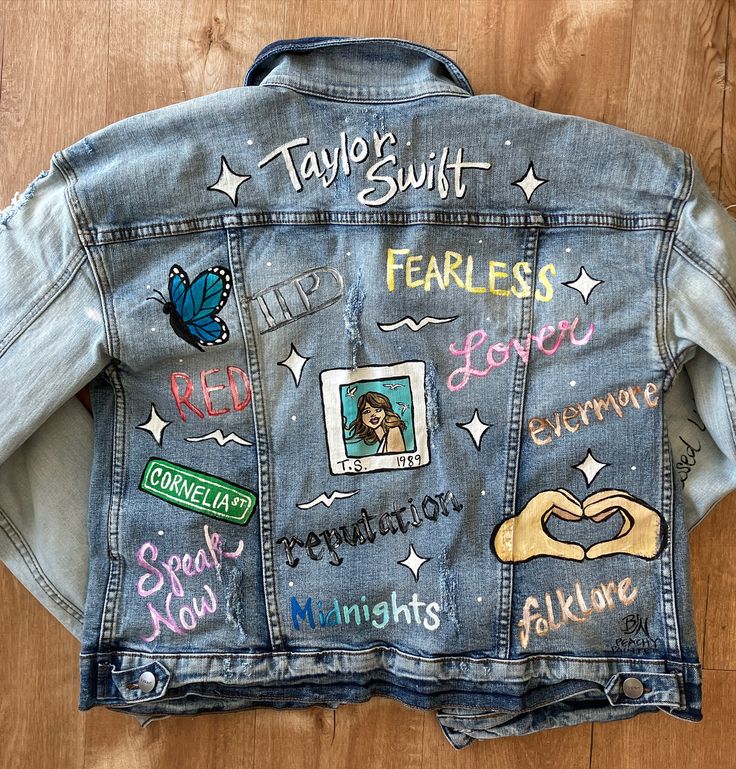 a jean jacket with pictures and words written on it