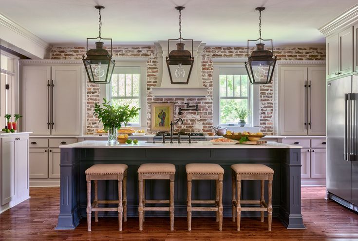 a kitchen with an island and four stools