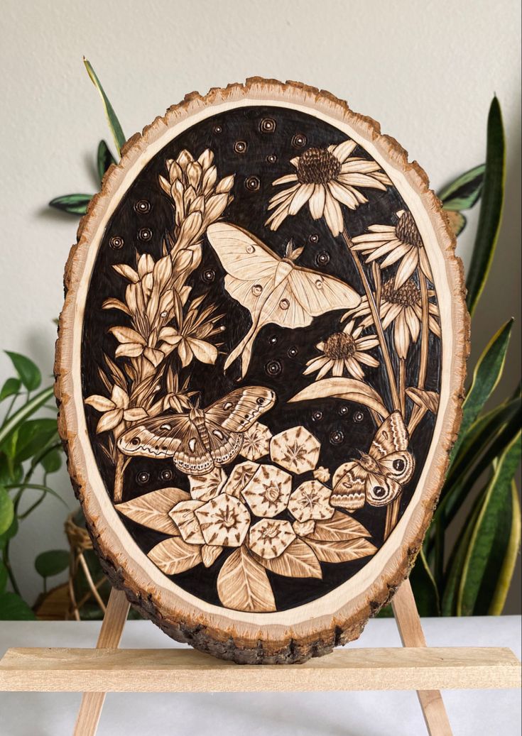 Hand burned bass wood moth abd flower design. @artbyKMF_ on insta Moth Wood Burning, Wood Burn Flowers Design, Wood Burned Designs, Wooden Burning Art, Flowers Wood Burning, Woodburning Ideas Design Patterns, Burn Wood Art, Pyrography Flowers, Flower Wood Burning