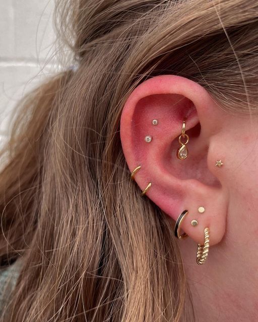 a close up of a person with ear piercings