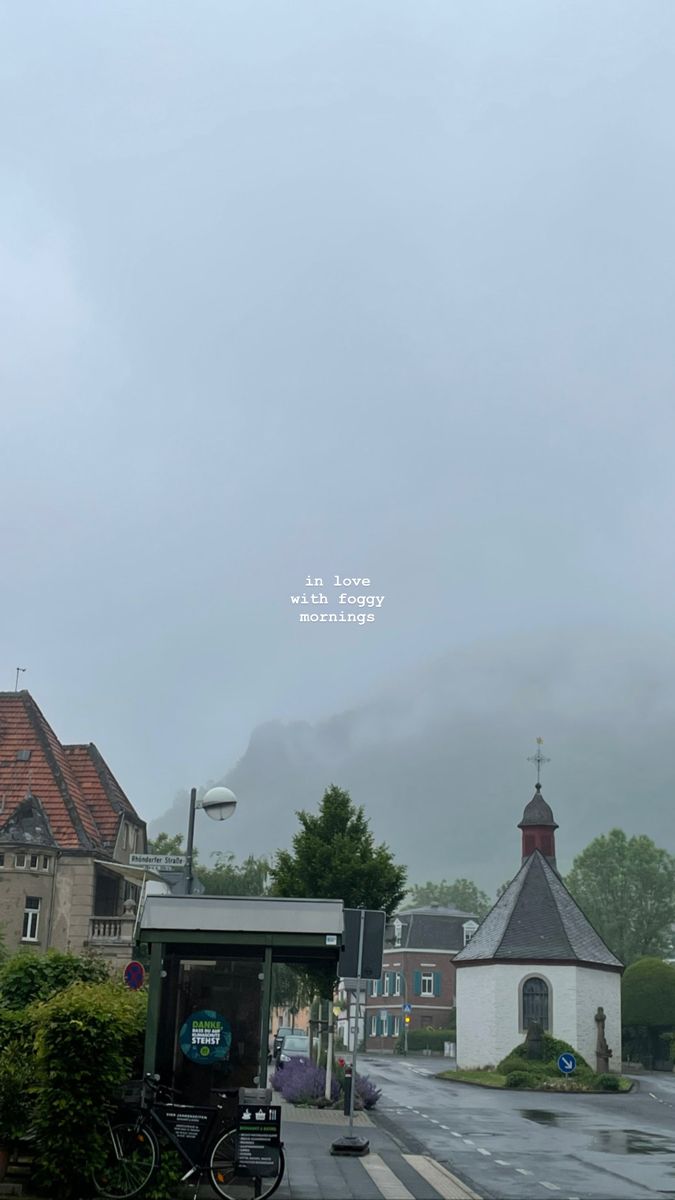 a bus stop on a rainy day with the sky in the background