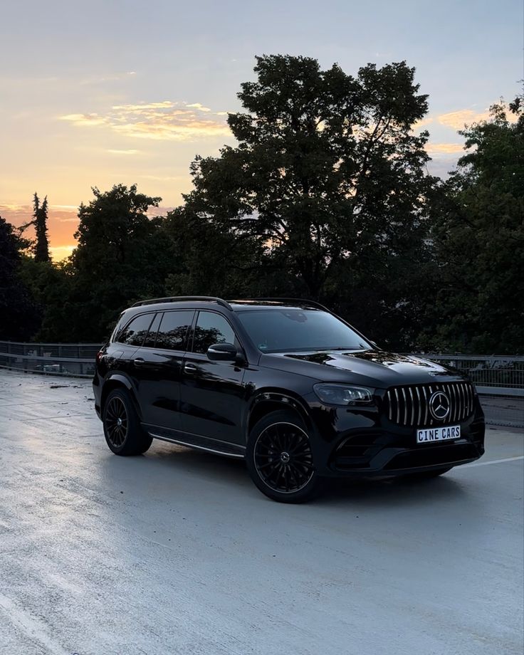 a black mercedes gls parked in the parking lot