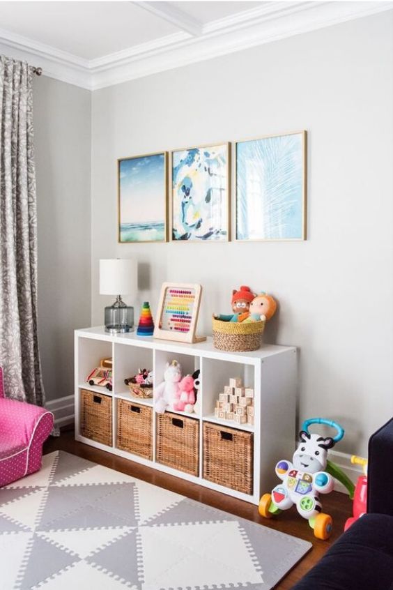 a child's room with pink furniture and pictures on the wall, rugs and curtains