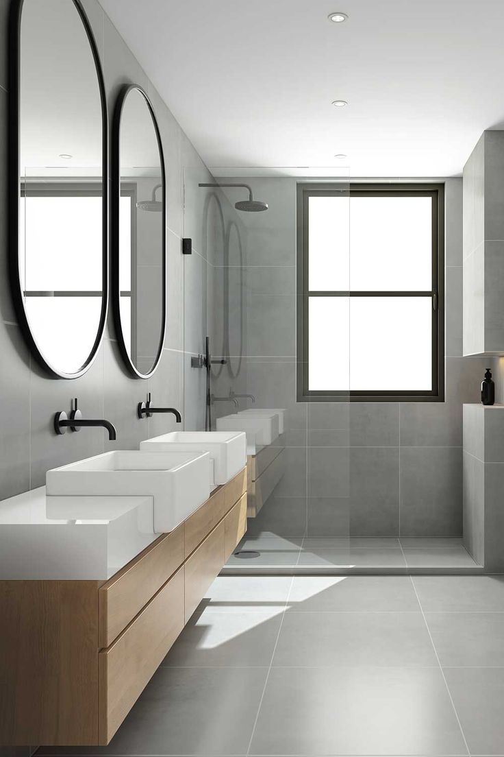 a modern bathroom with two sinks and three mirrors on the wall next to each other