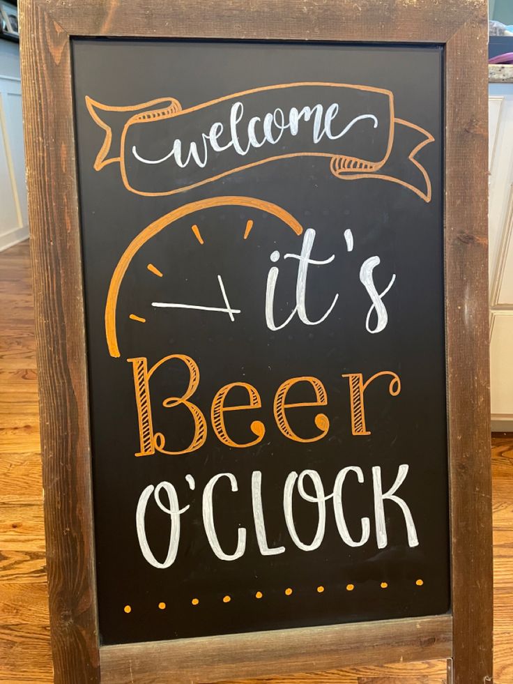 a chalkboard sign that says welcome it's beer o'clock