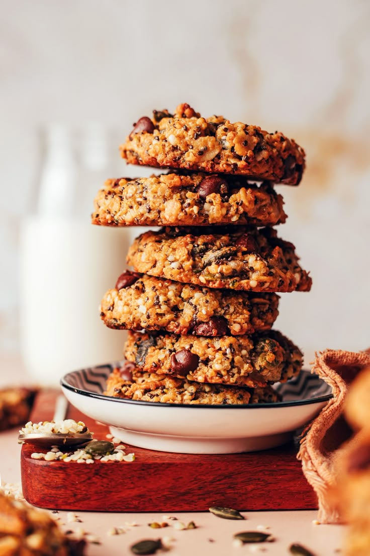 a stack of cookies sitting on top of a plate next to a glass of milk