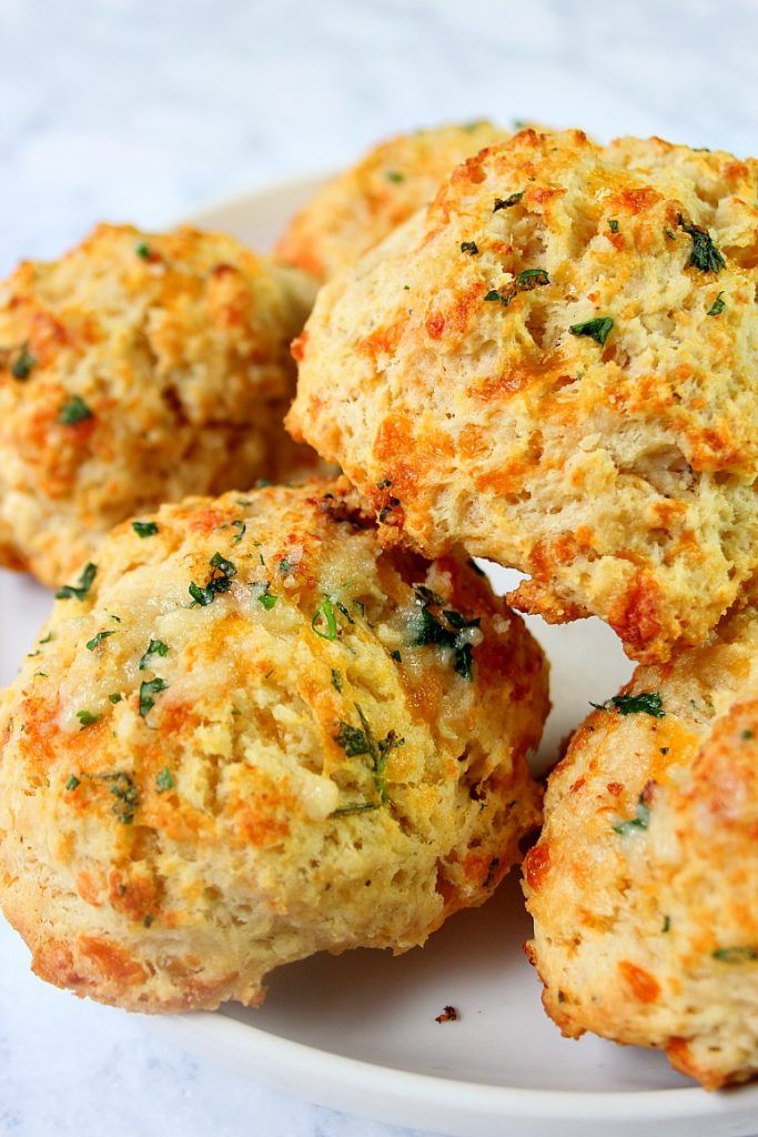 several crab cakes on a white plate with parsley