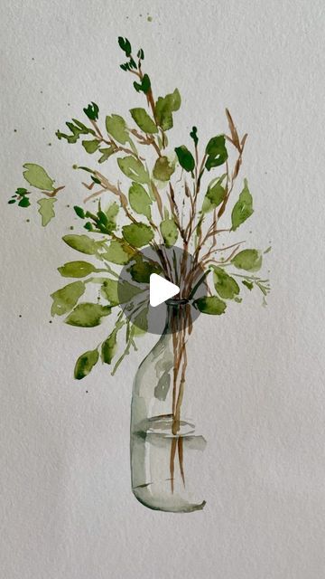 watercolor painting of green leaves in a glass vase with a white wall behind it