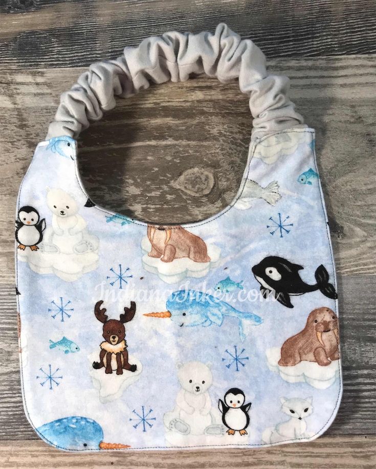 a bib with animals and penguins on it