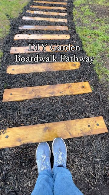 a person standing on a wooden path with the words diy garden boardwalk pathway above them