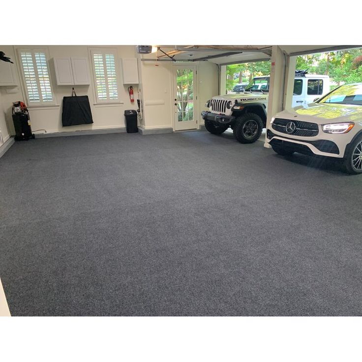 an empty garage with two cars parked in it