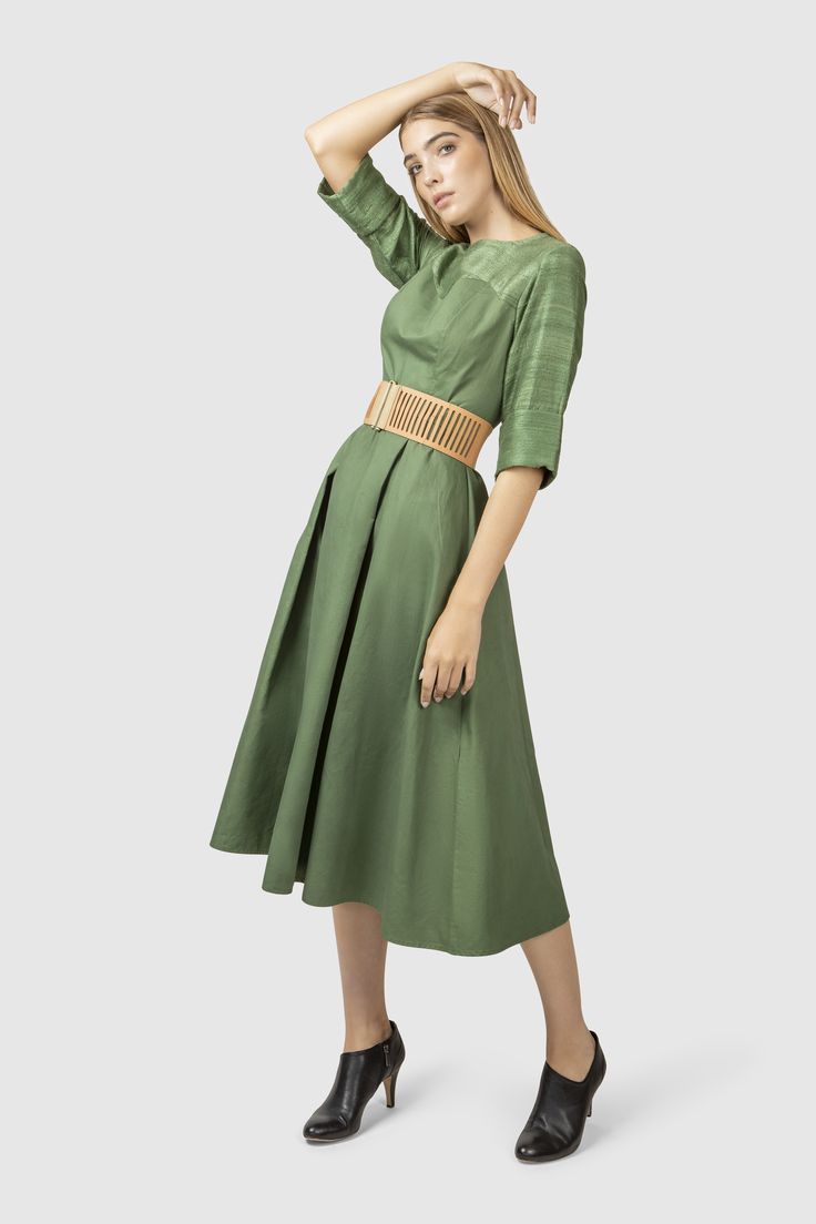 Influenced by the endless expanse of forest and the mind clouded by color green, this fit and flare dress is tailored in a beautiful green tone.   Fabric: Shell: 100% wool, hand weaved in India Lining: 100% cotton Green Fitted A-line Pleated Dress, Chic Green A-line Pleated Dress, Green Midi Length Silk Dress, Green Midi Dress With Pleated Bodice, Green Silk A-line Midi Dress, Chic Green Linen Midi Dress, Green Flared Skirt Dress For Spring, Chic Green Midi Linen Dress, Green Silk Dress With Pleated Bodice