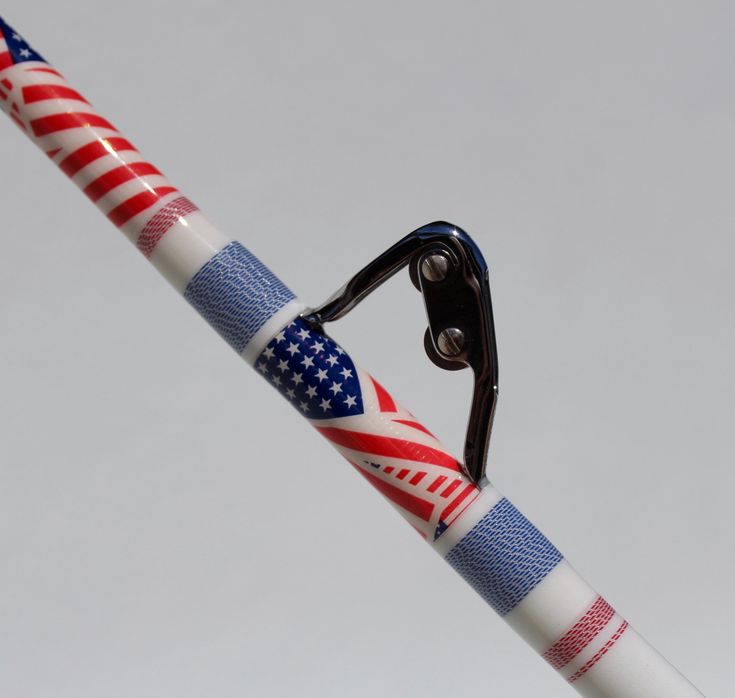 a pair of scissors with an american flag design on it, attached to a pole