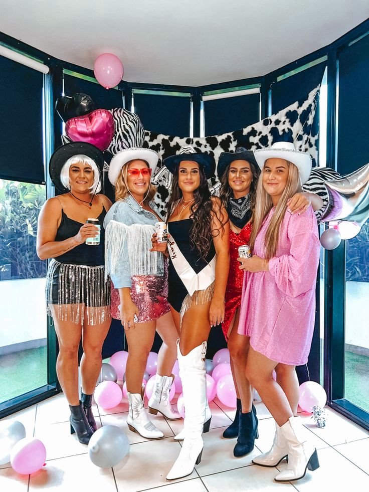 four women dressed up in costumes posing for the camera