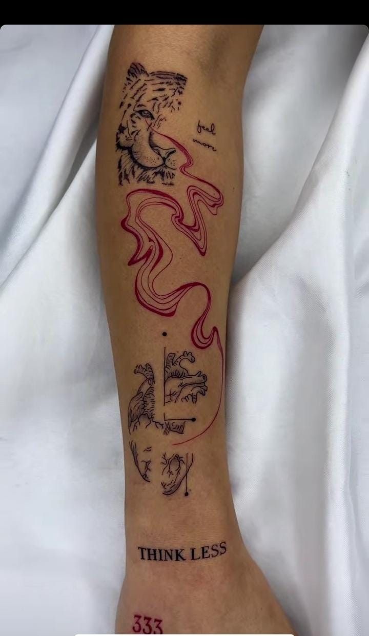 a person with a tattoo on their leg that says think less and has a tiger in it