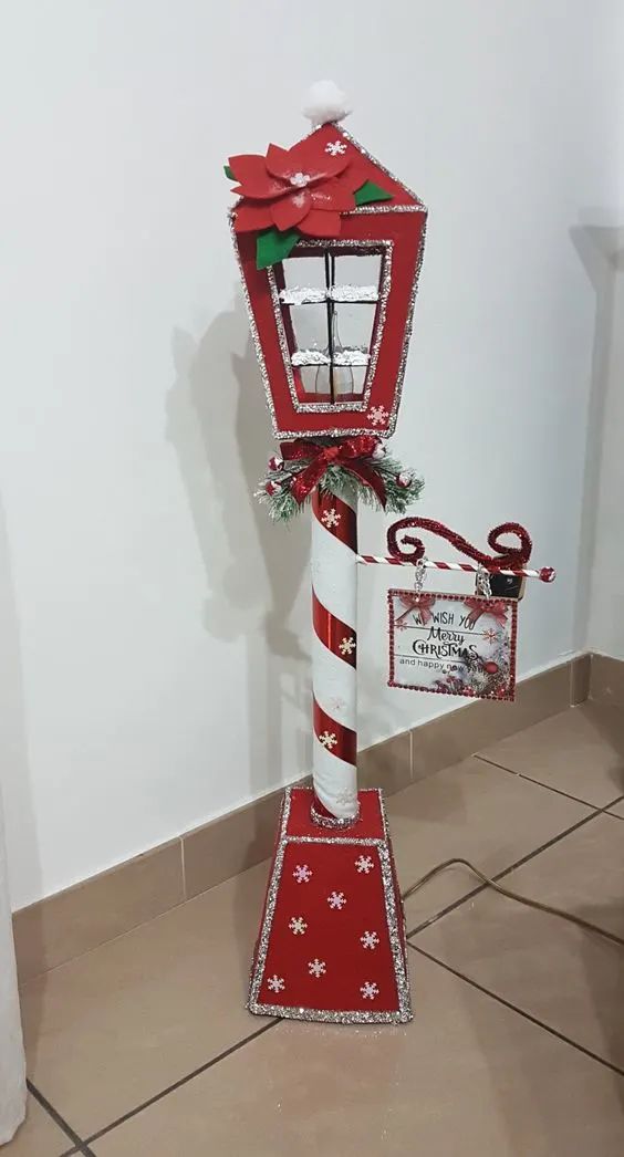 a red and white mailbox decorated with christmas decorations