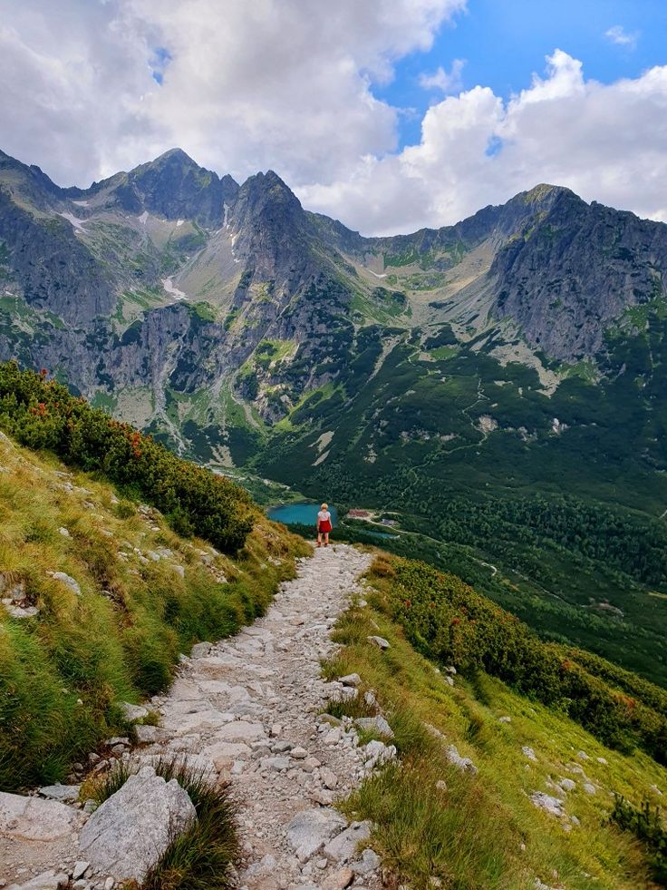 a person walking up a trail in the mountains