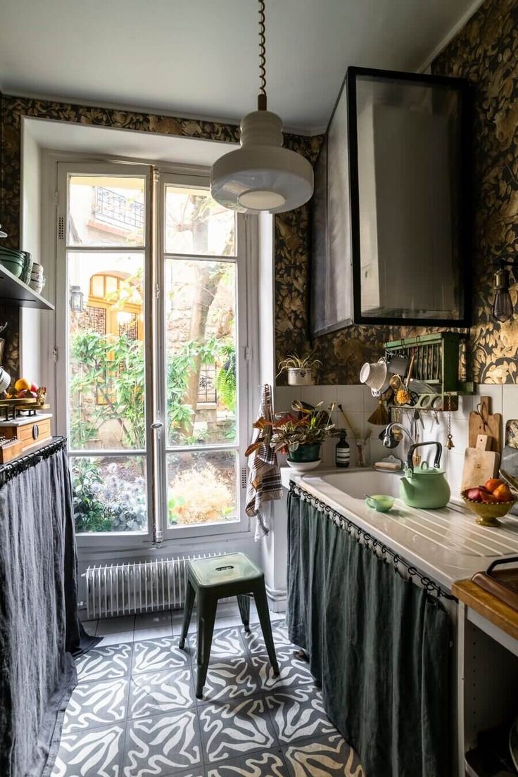 the kitchen is decorated with wallpaper and curtains