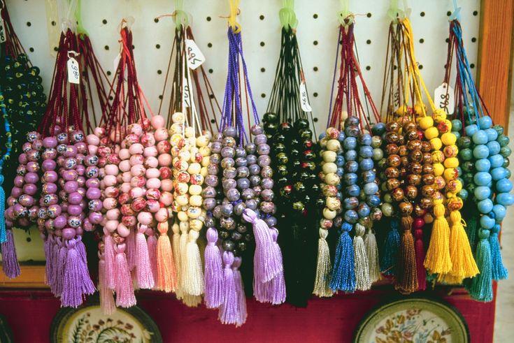 many different colored tassels are hanging on the wall