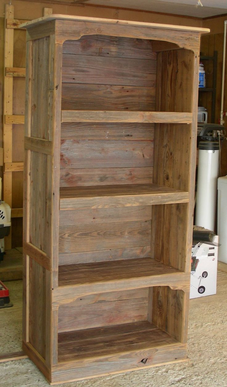 a wooden bookcase sitting in the middle of a room