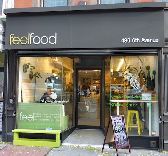 a store front with an advertisement on the window for a restaurant called feelfood