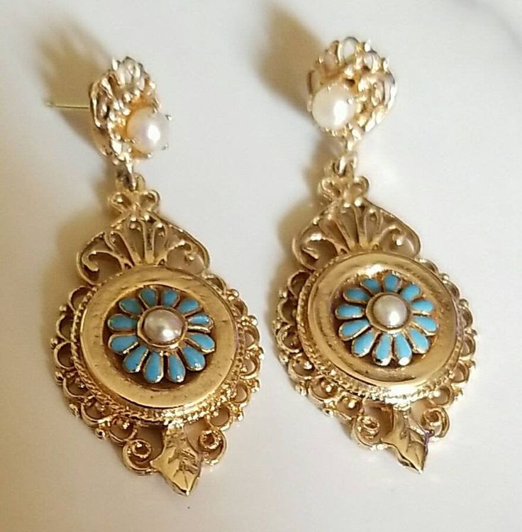 "Pair of 14K yellow gold 19th century Victorian blue enamel and saltwater cultured pearl Victorian dangle style earrings. Attached to the back of each earring is a post and 14K yellow gold friction fit back for fastening. Each earring measures approximately 40.00 mm long and 20.00 mm wide. The saltwater cultured pearls measure approximately 3.00 mm. The pair of earrings weigh 9.90 grams. Stamped \"14K\". The pair of earrings are in beautiful condition. The earrings come in a quality earring box. Victorian Enamel Jewelry For Formal Events, Victorian Enamel Jewelry For Formal Occasions, Heirloom Gold Earrings For Collectible, Elegant Enamel Earrings For Wedding, Victorian Enamel Jewelry For Wedding, Blue Elegant Earrings, Elegant Pierced Enamel Jewelry, Elegant Enamel Wedding Earrings, Antique Yellow Gold Earrings Stamped 14k