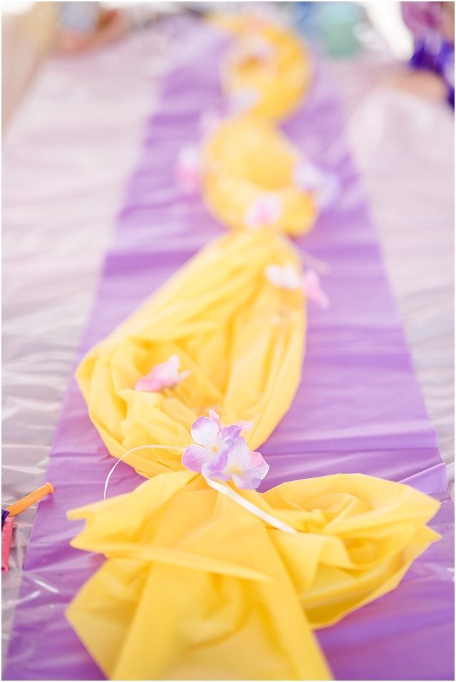 purple and yellow table runners with flowers on them for a party or wedding reception at the beach