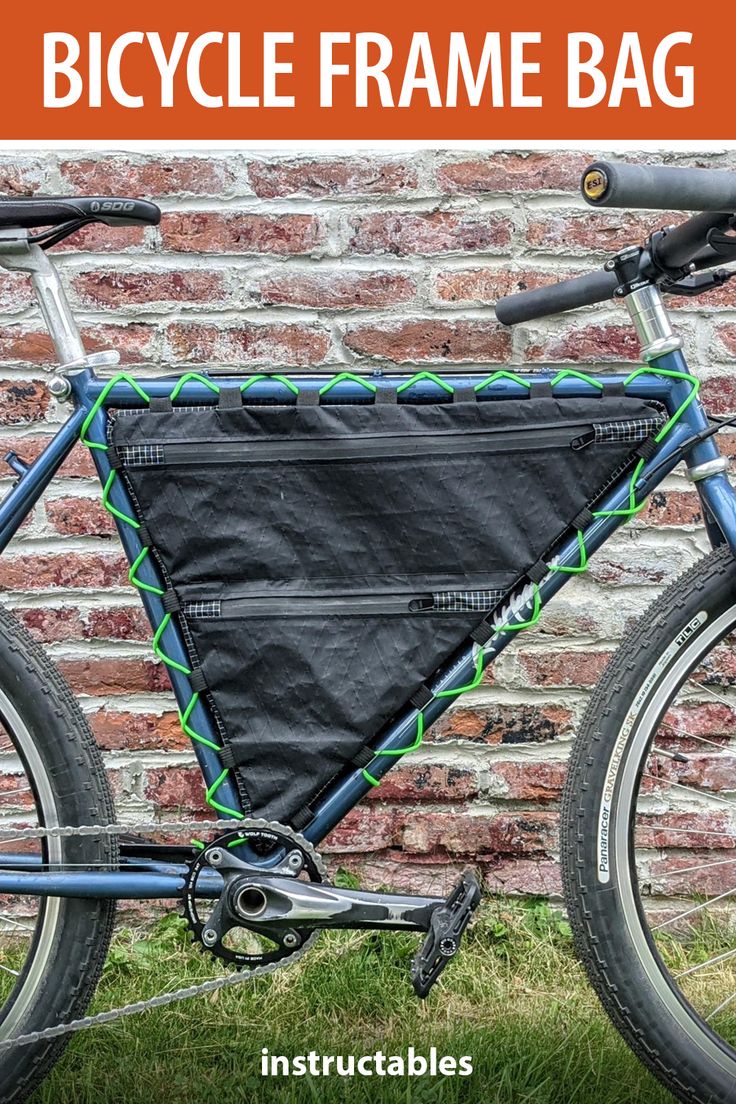 a bicycle frame bag attached to the back of a bike in front of a brick wall