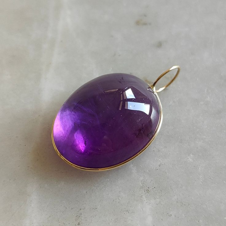 This stunning Pendant is set in 14k Solid Yellow Gold with Natural Purple Amethyst with utmost precision. It is a unique gemstone Pendant for nearly every occasion and is completely hassle-free jewelry. ITEM DETAILS: * Gem: Purple Amethyst * Gem Size: 20x25mm * Gem Shape: Oval Fix Loop * Gem Weight: 41.25 carats * Gold Purity: 14KT  * Gold Weight: 0.47 gram * Total Weight of the Pendant: 8.72 gram The Gold purity is guaranteed and it comes with authentic 14KT gold hallmark. Since my items are ha Formal Purple Cabochon Gemstones, Elegant Amethyst Cabochon Gemstones, Elegant Cabochon Amethyst Gemstones, Classic Amethyst Pendant Jewelry, Purple Polished Gemstones Fine Jewelry, Amethyst Pendant With Polished Finish, Purple Gemstones With Polished Finish Fine Jewelry, Purple Polished Gemstones For Fine Jewelry, Fine Jewelry Purple Cabochon