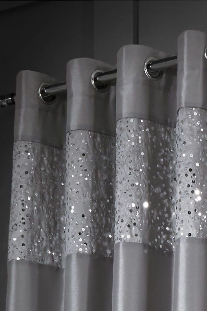 a curtain with silver sequins hanging from it's side