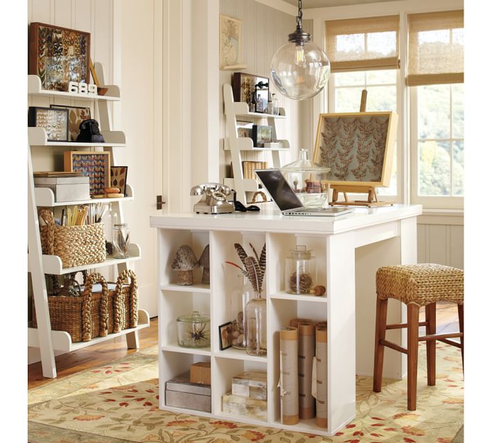 a white desk with shelves and baskets on it