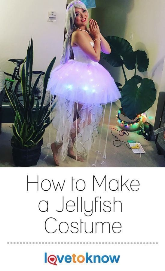 a woman dressed as a jellyfish costume standing in front of a plant with the words how to make a jellyfish costume