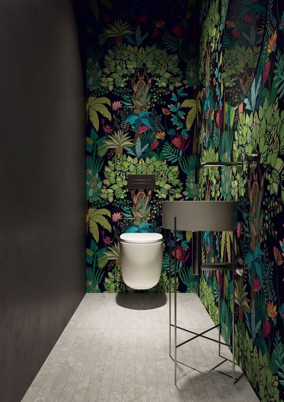 the bathroom is decorated with colorful wallpaper and a plant pattern on the wall behind the toilet