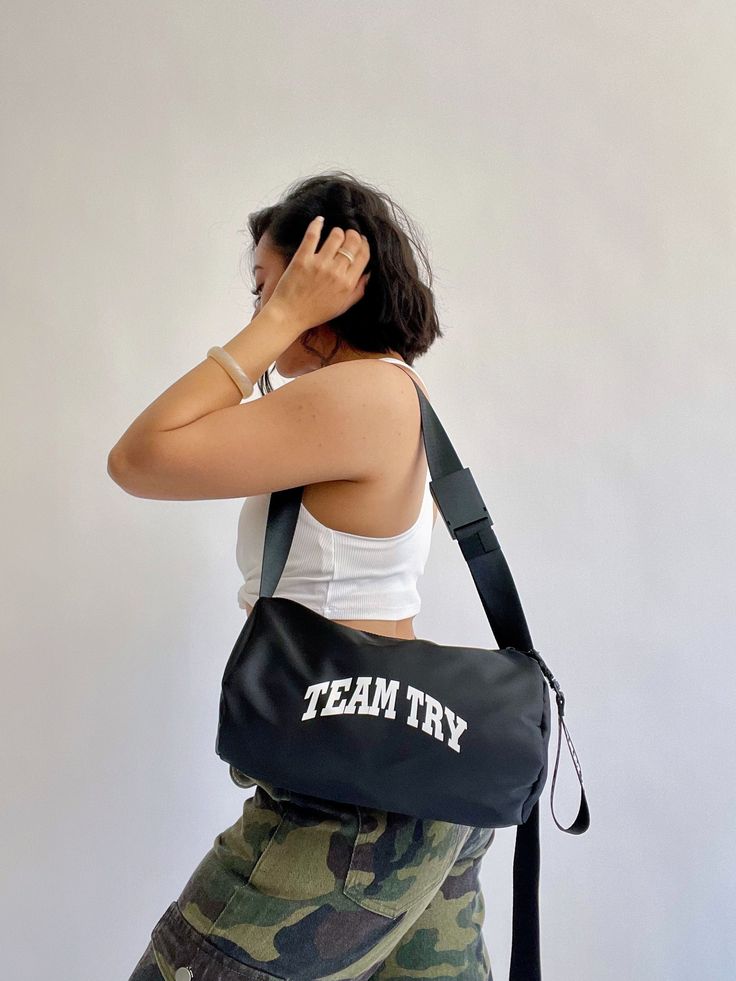 Secure The Bag! Our mini crossbody sports gym bag features a smooth double zipper, adjustable shoulder strap, and high quality metal buckle with our logo strap. The best part? It's water repellant. So whether it's sunny out or it's pouring, there's no excuse to get out and clock tf in. The perfect size for men and women. Whether you're a minimalist or an overpacker, our bag does it all. Sportswear or streetswear, get you a bag that can do both. 11.5"L x 6"W x 6"H Nylon Shoulder Bag With Adjustable Strap For Gym, Large Capacity Crossbody Sports Bag, Trendy Sports Shoulder Bag With Adjustable Strap, Large Capacity Crossbody Shoulder Bag For Sports, Sporty Large Capacity Crossbody Shoulder Bag, Large Capacity Crossbody Sports Shoulder Bag, Versatile Shoulder Bag With Adjustable Strap For Sports, Nylon Crossbody Shoulder Bag For Sports, Sports Nylon Crossbody Shoulder Bag