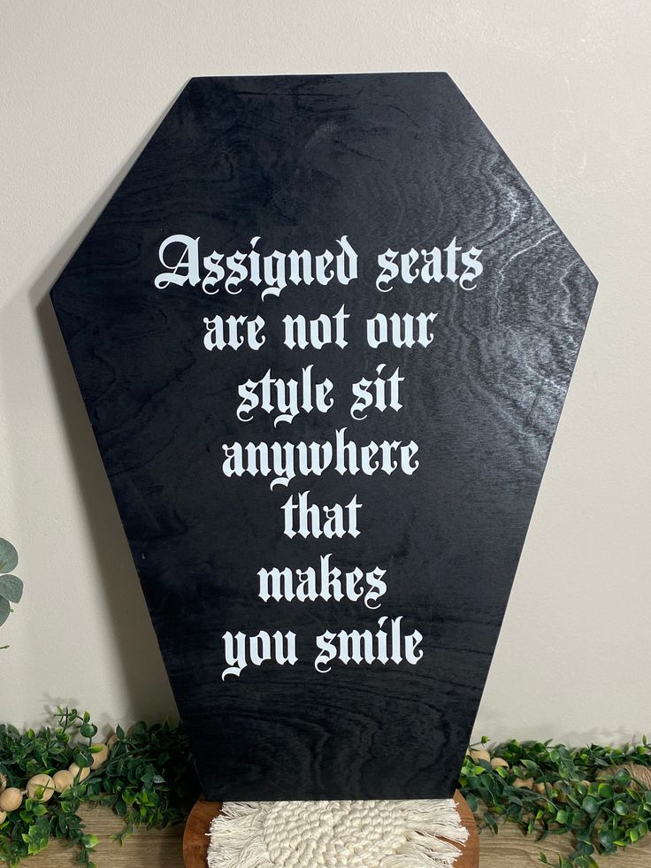 a black and white sign that says, assigned seats are not our style sit anywhere that makes you smile