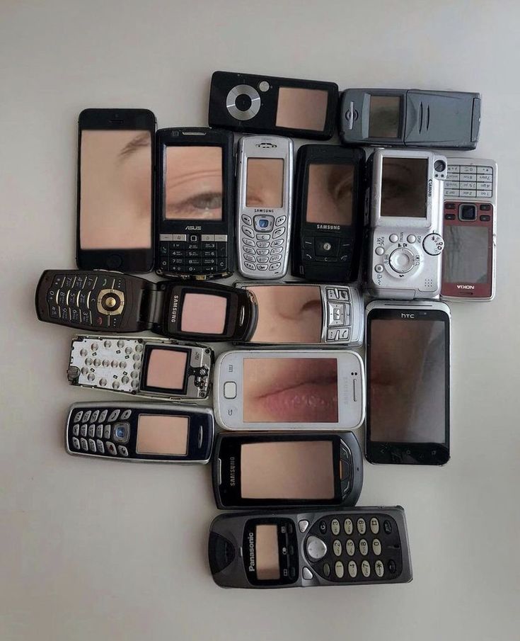 there are many different types of cell phones on the table, each with their own individual's face