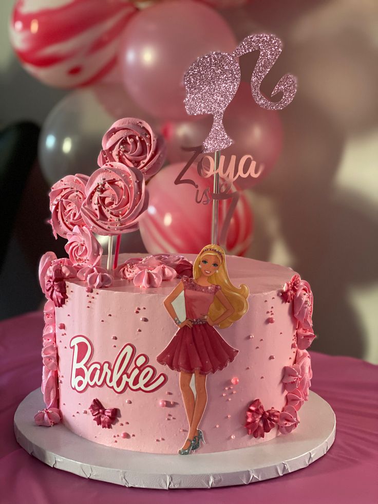 a barbie birthday cake with pink frosting and decorations